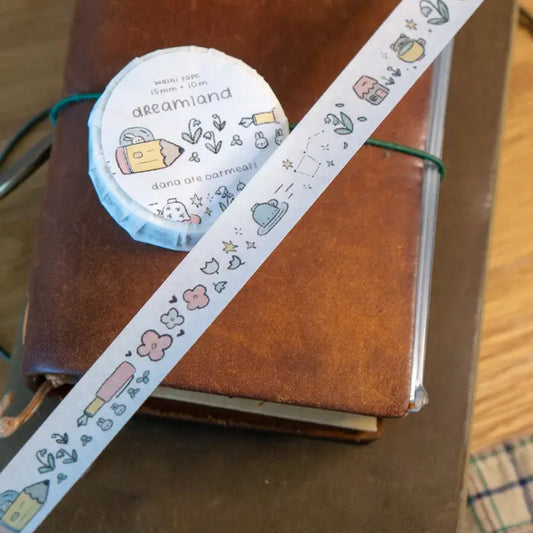 Decorative tape with cartoon designs on a brown notebook