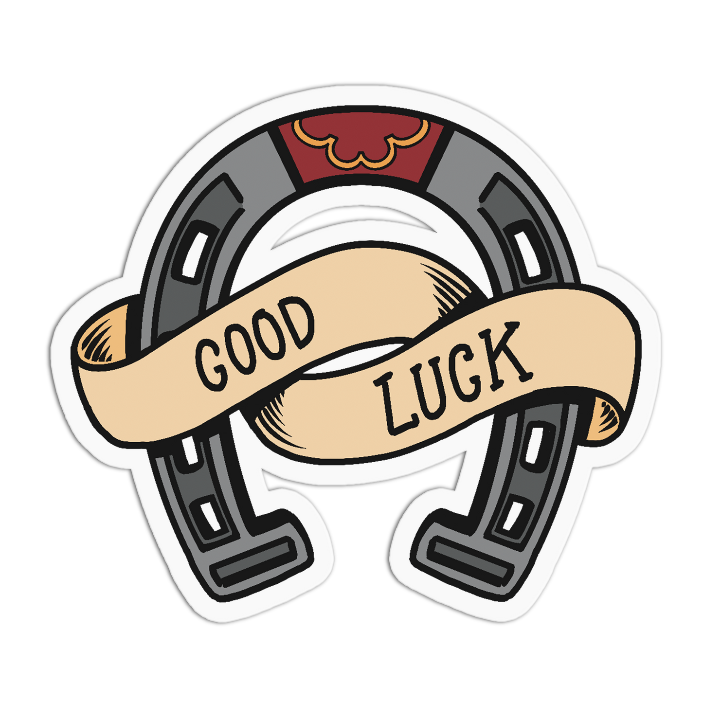 A die-cut sticker featuring a horseshoe with a beige banner across it that reads 'GOOD LUCK' in black text, on a white background.