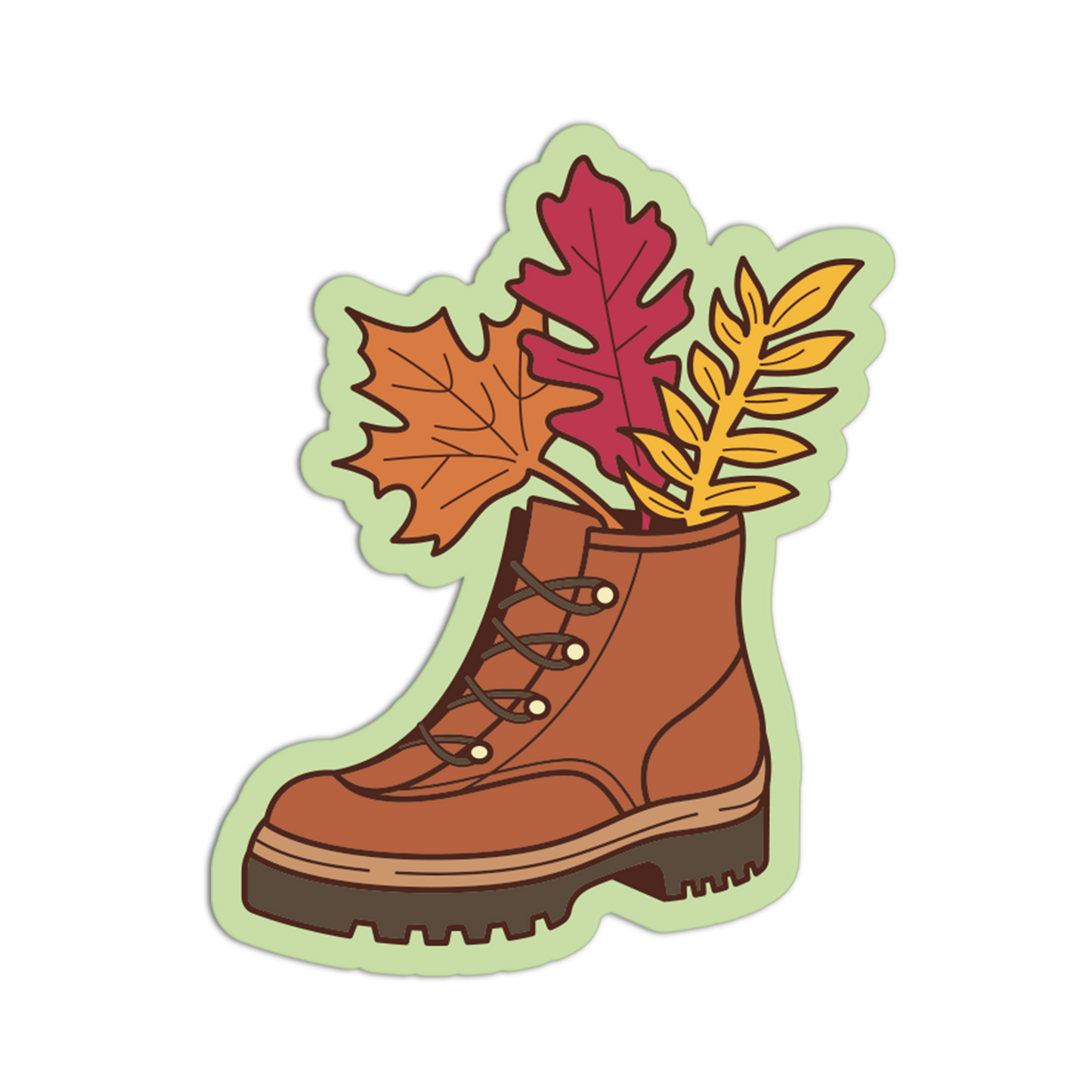 A die-cut sticker or graphic of a brown lace-up boot with autumn leaves sticking out of the top, shown on a plain white background.