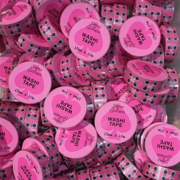 Pink washi tape rolls with visible brand name on a pink background