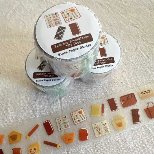 Two rolls of decorative tape with printed designs on a textured surface