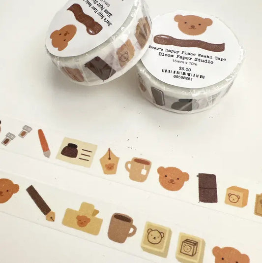 Two rolls of decorative tape with bear designs on a white surface.
