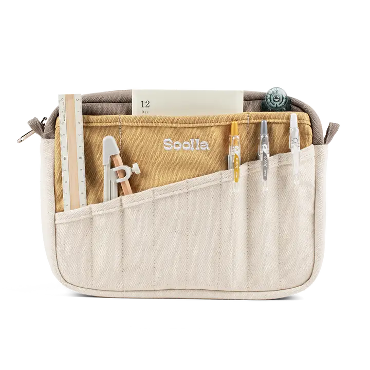 Beige organizer bag with tools and a ruler on a white background