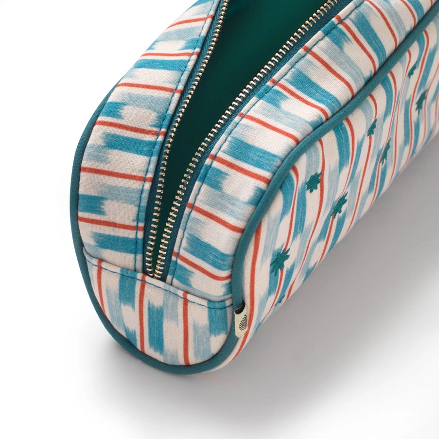 Oval-shaped fabric case with zipper, featuring blue, red, and white pattern on a light gray background.