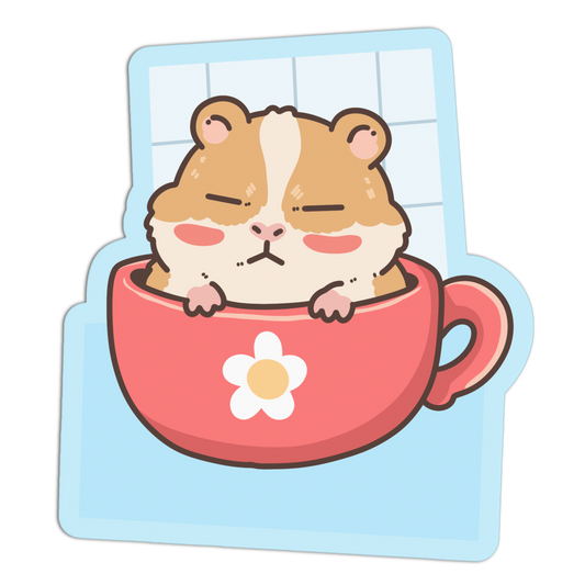 A cute cartoon sticker or decal showing a brown and cream hamster sleeping inside a pink cup with a white flower on the front, set against a light blue grid background.