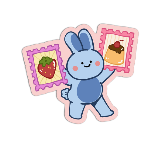 A cartoon blue bunny sticker or decal holding two pink postage-style cards, one with a strawberry illustration and the other with a dessert illustration, on a plain white background.