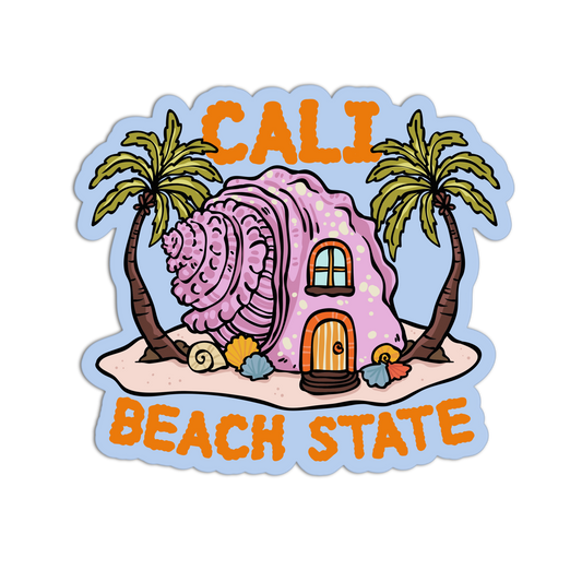 A die-cut sticker featuring a whimsical beach house made from a large pink seashell, flanked by two palm trees on a sandy shore. The sticker has orange text reading 'CALI' at the top and 'BEACH STATE' at the bottom, set against a light blue sky background.