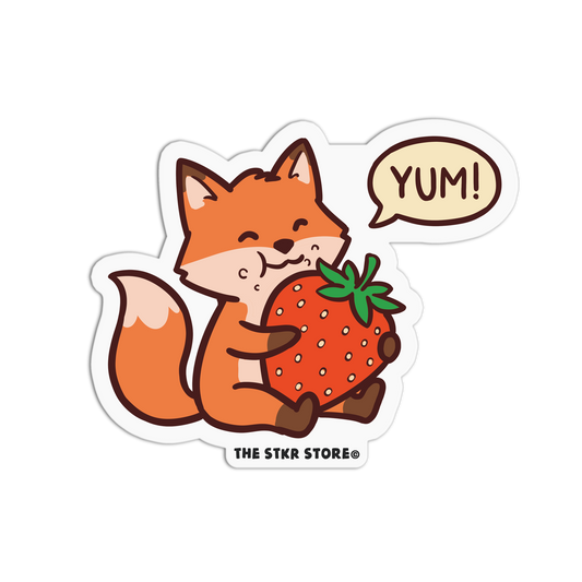 Sticker of a fox holding a strawberry with a 'YUM!' speech bubble, from The STKR Store.