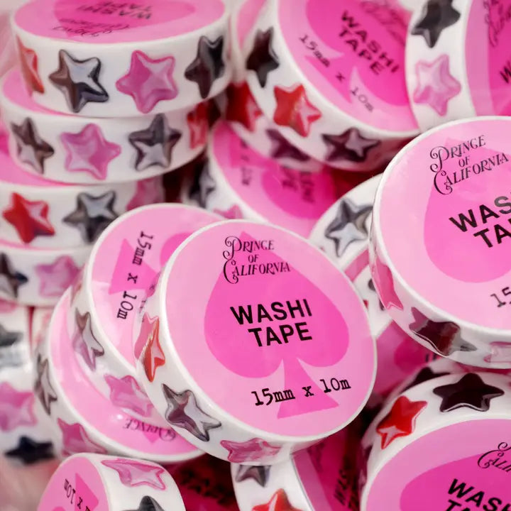 Collection of washi tape rolls with pink labels featuring stars and text.