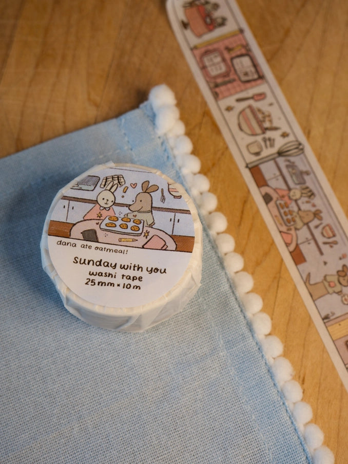 Roll of washi tape with cartoon design on a wooden surface