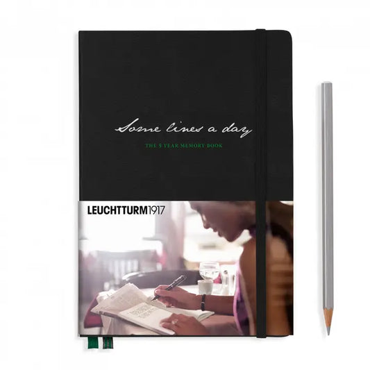 Black notebook with 'Leuchtturm1917' branding and a blurred photo of a person writing on the cover.