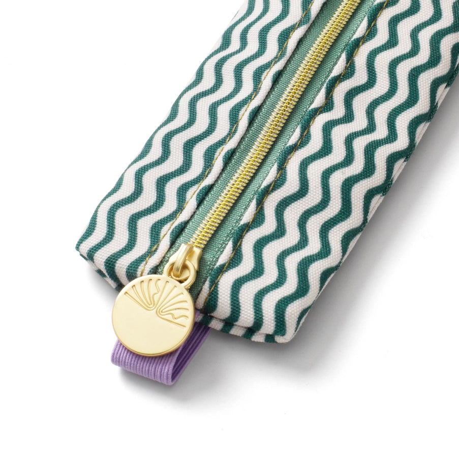Pouch with green and white wavy pattern, gold zipper, and purple ribbon on a white background