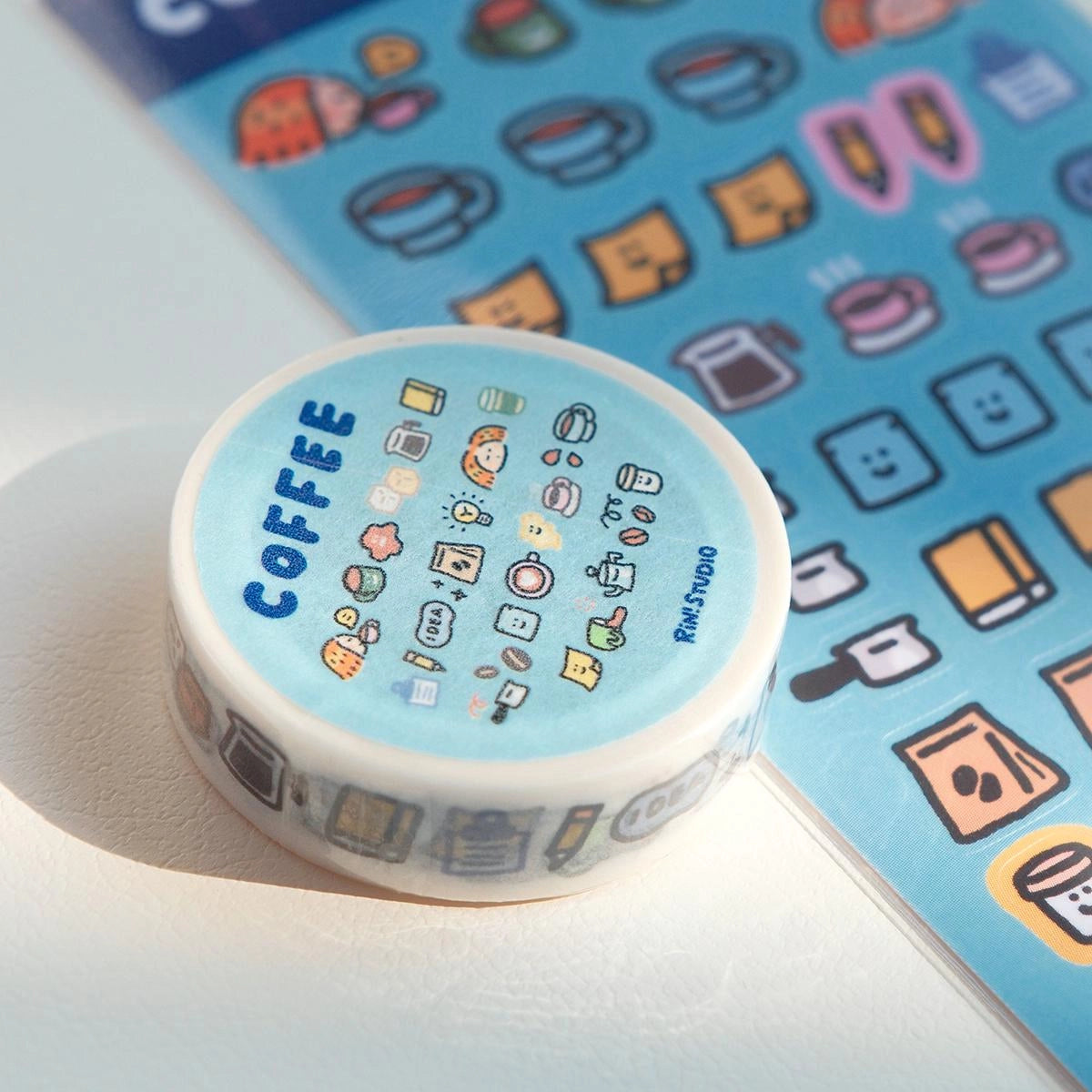 Decorative tape with coffee-themed design on a blue background with icons