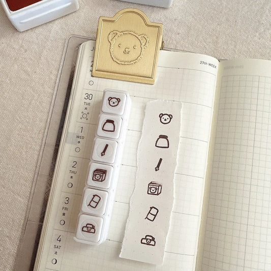 Stamps with bear and icon designs on a notebook page
