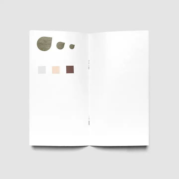 An open white booklet or palette spread on a light gray background, showing three irregular neutral shapes and three small color swatches on the left page.