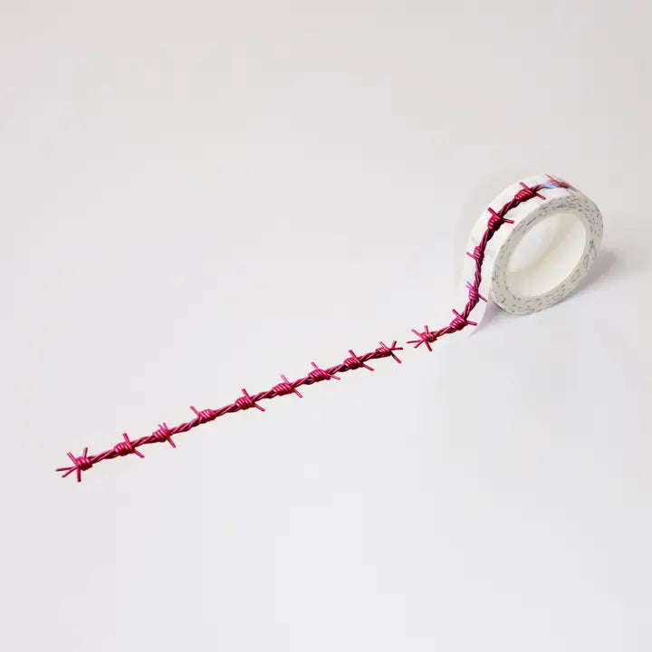 Roll of pink barbed wire on a white background