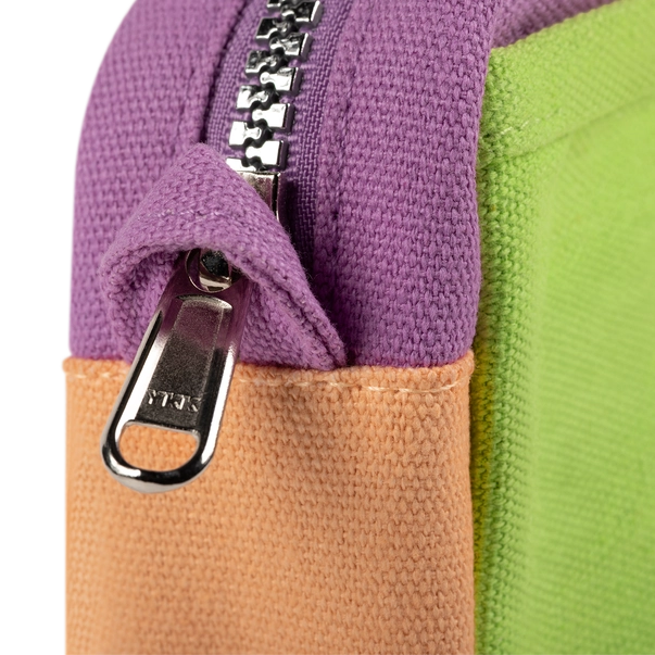 Close-up of a multicolored bag with a zipper featuring the YKK brand.