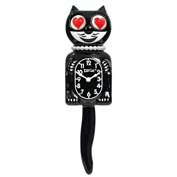 Black cat-shaped clock with red heart eyes on a white background