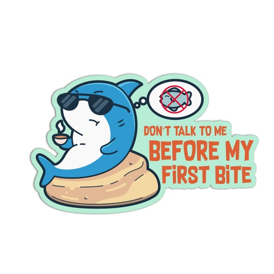 Cartoon shark sticker with sunglasses and text 'Don't talk to me before my first bite' on a white background