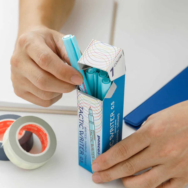 Person opening a box of Pilot Tactic Writer markers with a close-up of the product.