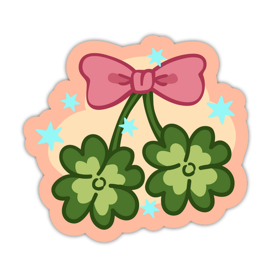 Decorative sticker with green clover leaves and a pink bow on a peach background with blue stars.