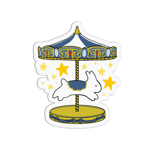 A die-cut sticker featuring a whimsical carousel design with a white rabbit on a gold and blue ride, surrounded by yellow stars on a white background.
