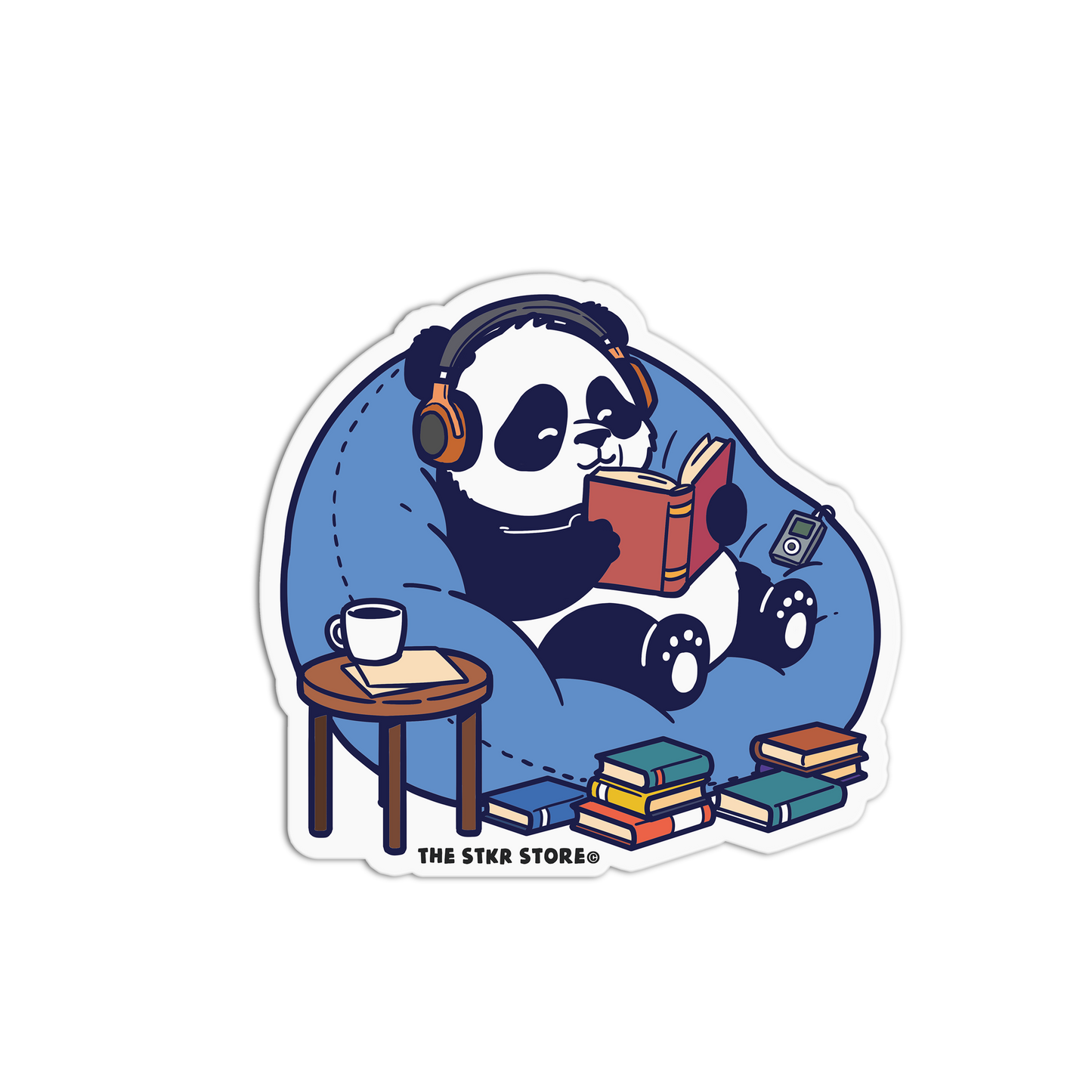 Sticker of a panda reading a book with headphones on, sitting on a bean bag chair with books around, on a white background.