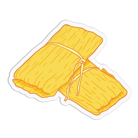 A die-cut sticker featuring a cartoon illustration of two golden-yellow tamales tied together with string, set against a solid white background.
