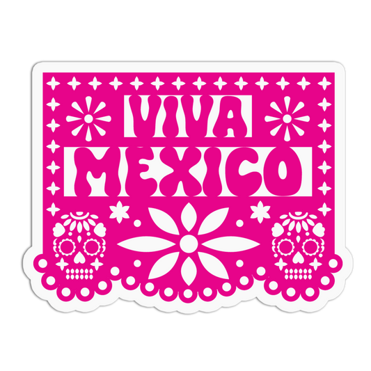 A bright pink rectangular papel picado banner with 'VIVA MEXICO' in bold white letters, decorated with sugar skull motifs and floral patterns, shown on a plain white background.