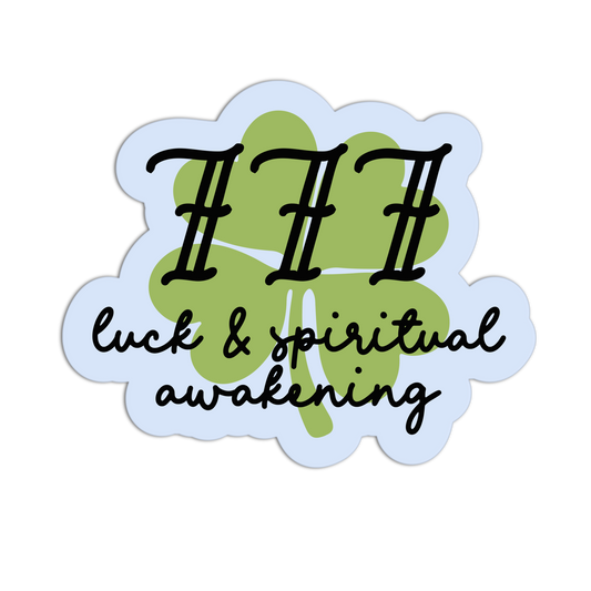 Sticker with three black dots, green clover, and text 'luck & spiritual awakening' on a light blue background