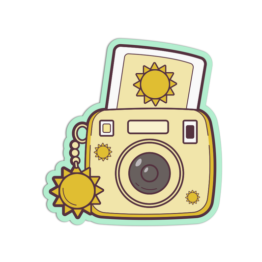 A cartoon-style sticker or decal of a retro instant camera with a sun motif, shown on a plain white background.