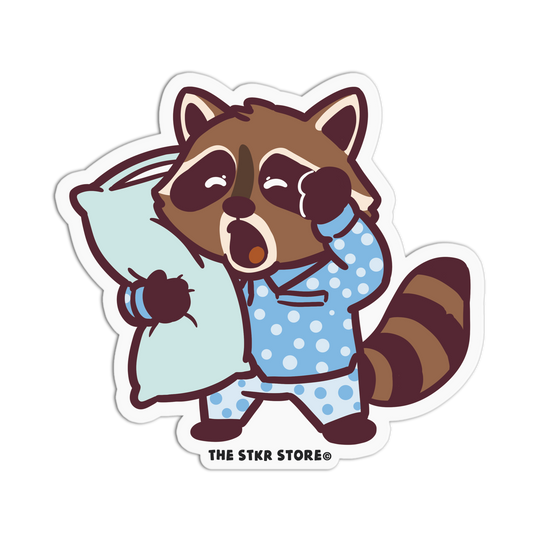 Cartoon raccoon in pajamas holding a pillow with 'The Stkr Store' logo.