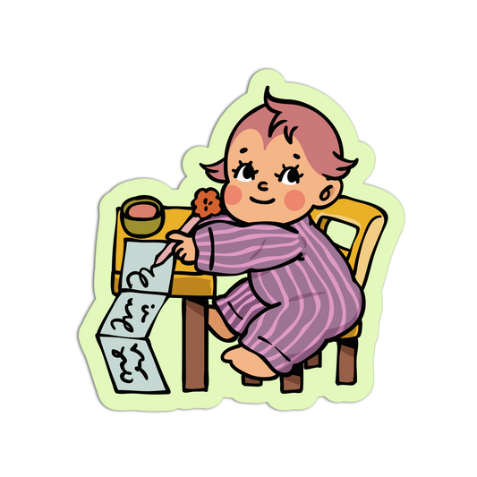 A cartoon sticker-style illustration of a child sitting at a small table and drawing, with a pale green die-cut outline on a plain white background.