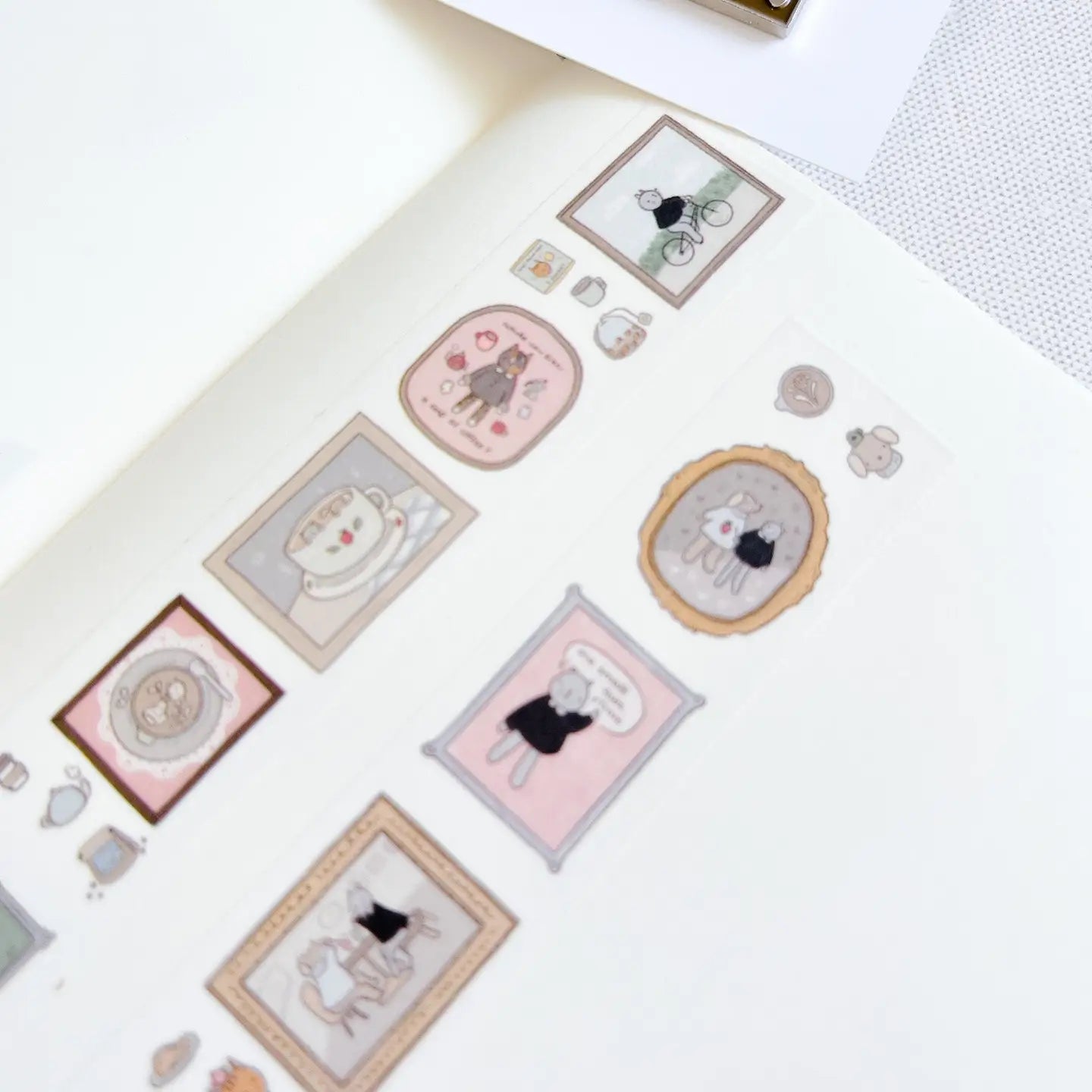 Collection of decorative stickers with cartoon cat designs on a white surface.
