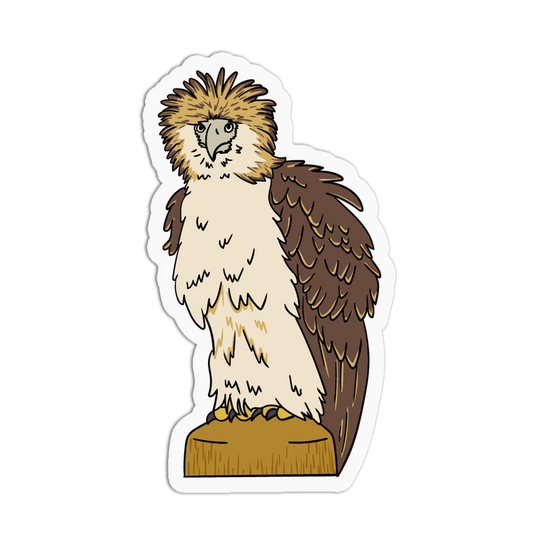 A die-cut sticker featuring a cartoon illustration of a large eagle or hawk with brown and cream feathers, standing on a tan perch, shown on a plain white background.